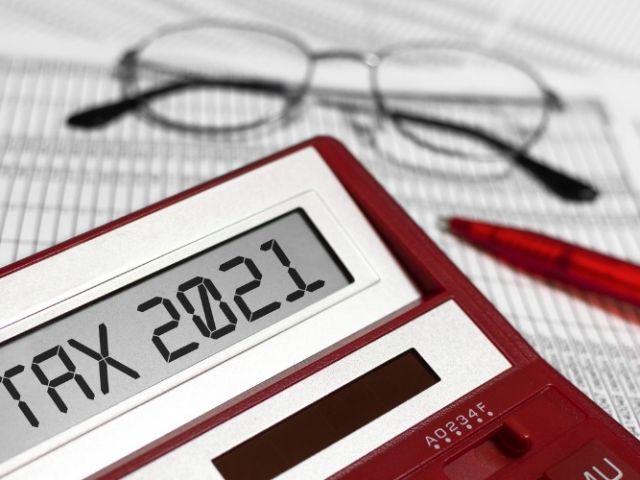 word-tax-2021-on-calculator-glasses-pen-and-the-calculator-on-the-picture-id1279361912