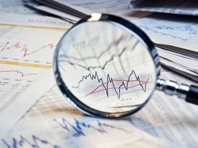 A magnifying glass over financial reports