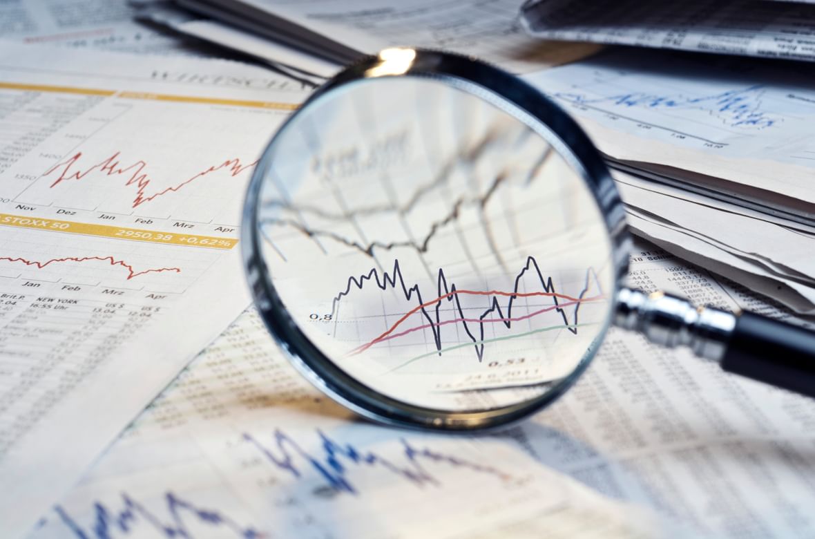 A magnifying glass over financial reports A magnifying glass over financial reports