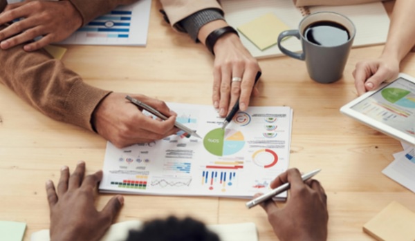 All hands meeting around some charts