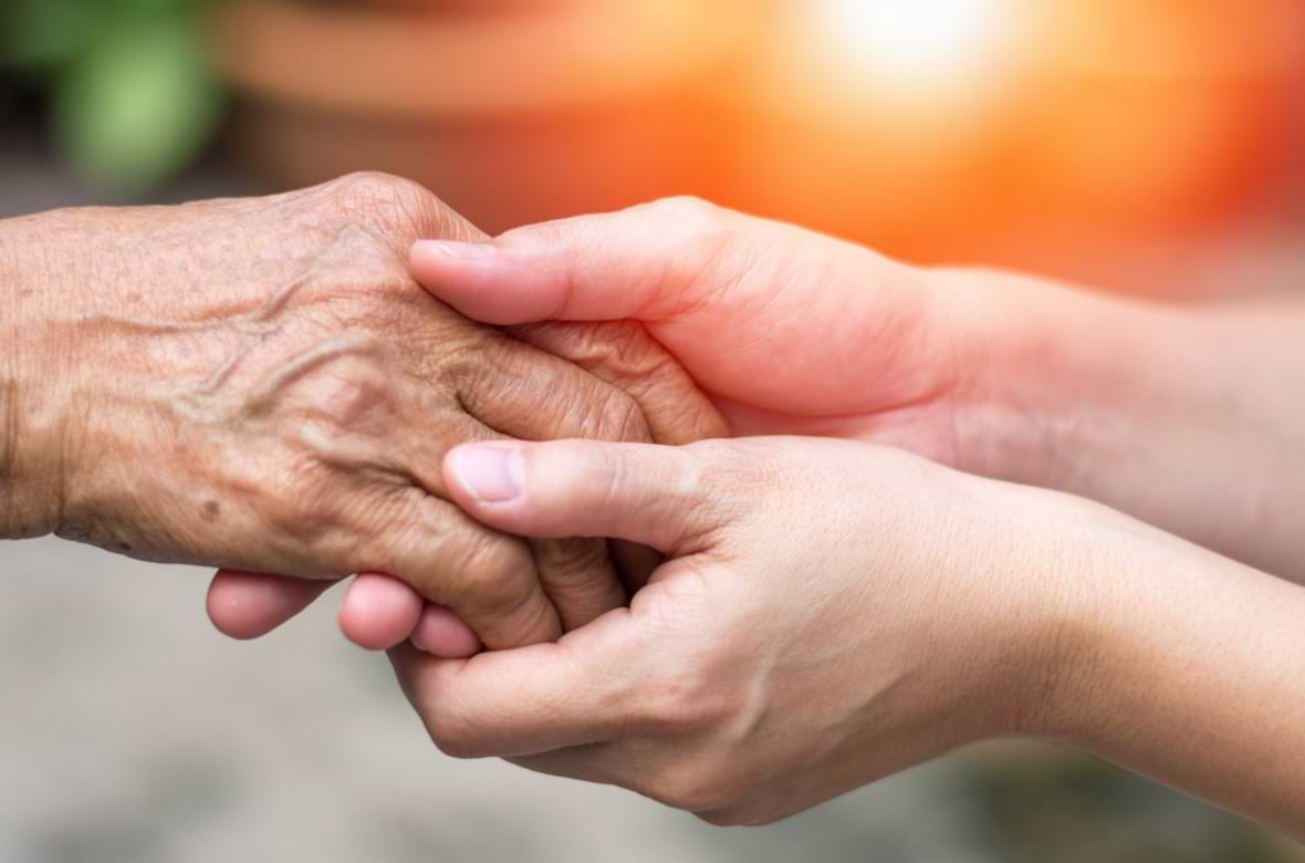 Younger person holding the hand of an elder Younger person holding the hand of an elder